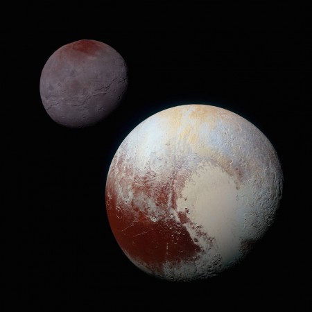 This composite of enhanced color images of Pluto (lower right) and Charon (upper left), was taken by NASA's New Horizons spacecraft as it passed through the Pluto system on July 14, 2015. nasa, Charon, Pluto, moon, dwarf planet,