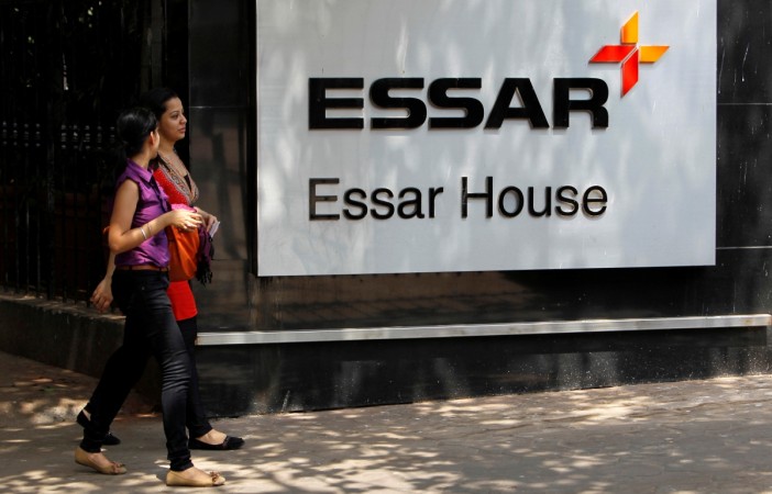 Employees walk past an Essar Group logo outside the company headquarters in Mumbai in this 2013 file photo. REUTERS/Vivek Prakash/File Photo Essar headquarters