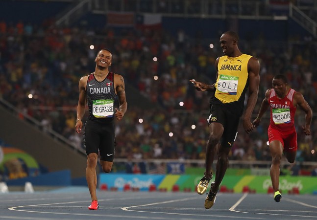 Andre de Grasse (L) and Usain Bolt during 200m semi-final at Rio Games. Andre de Grasse and Usain Bolt