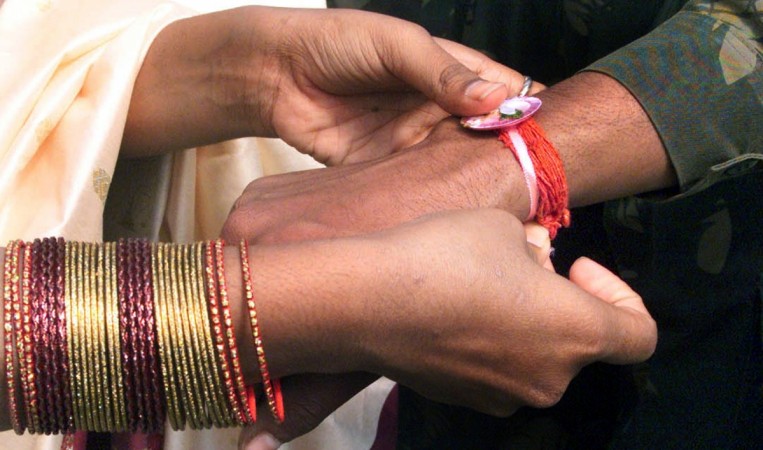 A woman ties rakhi on the wrists of a during the Raksha Bandhan festival in Gulmarg in Srinagar Raksha Bandhan 2017, Rakhi 2017