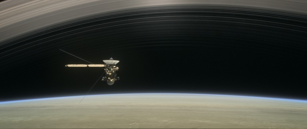 This artist's rendering shows Cassini as the spacecraft makes one of its final five dives through Saturn's upper atmosphere in August and September 2017. Cassini