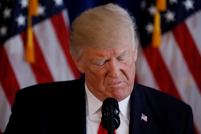 US President Donald Trump reads from a prepared statement as he delivers remarks on the protests in Charlottesville, Virginia, from his golf estate in Bedminster, New Jersey US, August 12, 2017. US President Donald Trump