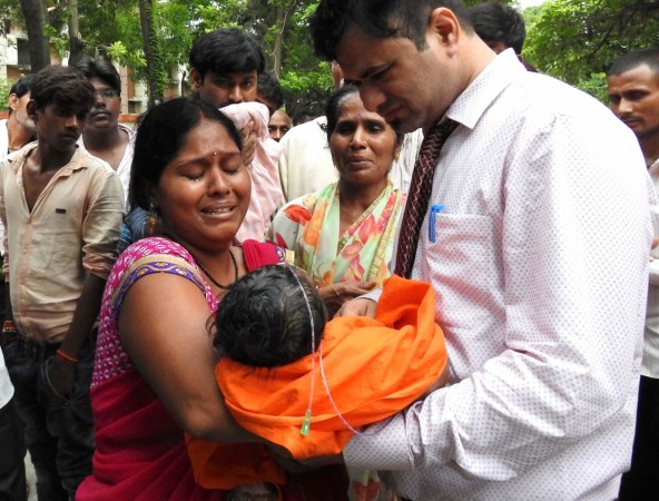 Relatives mourn the death of a child at the Baba Raghav Das Hospital in Gorakhpur, in the northern Indian state of Uttar Pradesh, on August 12, 2017. Gorakhpur