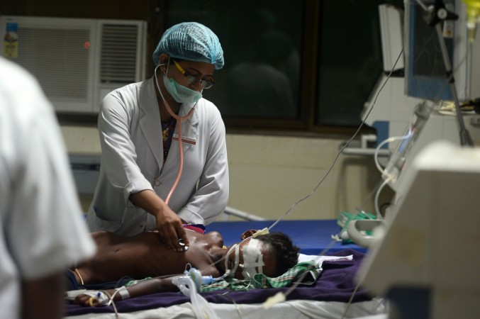 Indian medical staff attend to a child admitted in the Encephalitis ward at The Baba Raghav Das Hospital in Gorakhpur, in the northern Indian state of Uttar Pradesh, on August 12, 2017. Gorakhpur