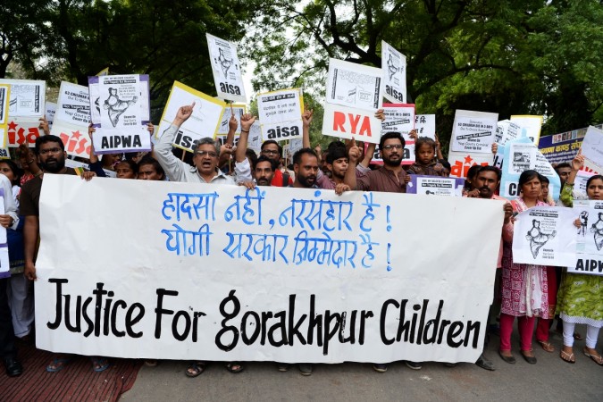 Activists and Indian students hold placards as they shout slogans during a protest rally against the recent death of at least 64 children at a government hospital in northern India that suffered oxygen shortages, in New Delhi on August 13, 2017. Gorakhpur