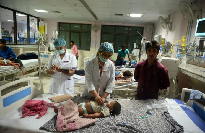 Indian medical staff attend to a child admitted in the Encephalitis ward at The Baba Raghav Das Hospital in Gorakhpur, in the northern Indian state of Uttar Pradesh, on August 12, 2017. Gorakhpur