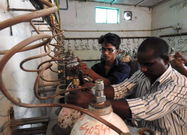 Indian workers examine oxygen cylinders at the Baba Raghav Das Hospital in Gorakhpur, in the northern Indian state of Uttar Pradesh, on August 12, 2017. Gorakhpur