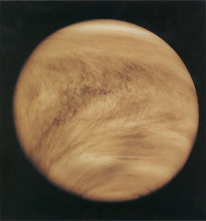As seen in the ultraviolet, Venus is striped by light and dark areas indicating that an unknown absorber is operating in the planet's top cloud layer Venus