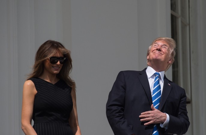 US President Donald Trump and First Lady Melania Trump look up at the partial solar eclipse from the balcony of the White House in Washington, DC, on August 21, 2017. The Great American Eclipse completed its journey across the United States Monday, with the path of totality stretching coast-to-coast for the first time in nearly a century. Solar Eclipse