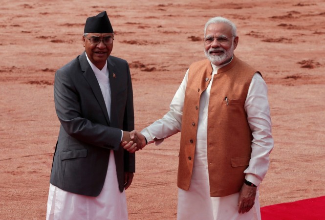 Nepalese Prime Minister Sher Bahadur Deuba shakes hands with his Indian counterpart Narendra Modi (R) during his ceremonial reception at the forecourt of India's Rashtrapati Bhavan presidential palace in New Delhi, India, August 24, 2017. Modi nepal PM