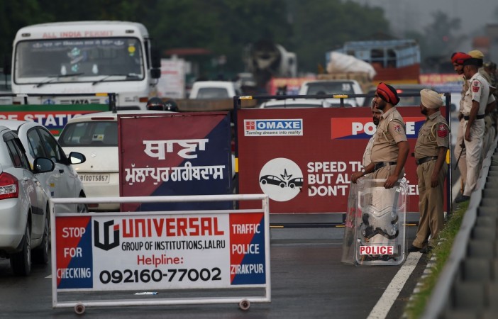 Indian security forces stand guard on the roadside in Panchkula, near Chandigarh, on August 24, 2017. Ram Rahim