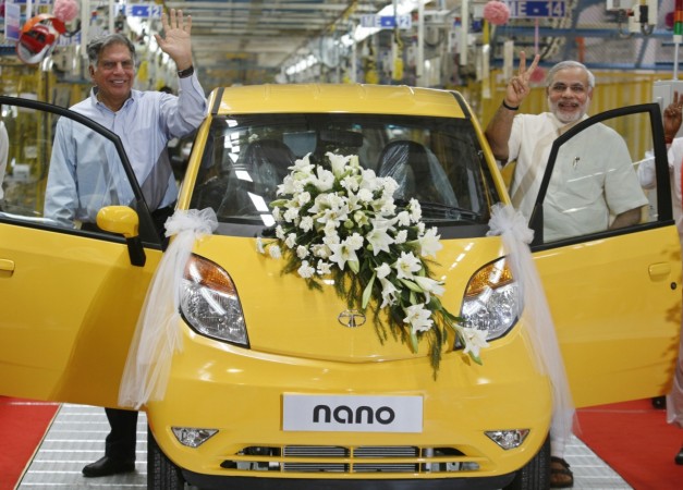 Ratan Tata (L), chairman of the Tata Group, and Gujarat's chief minister Narendra Modi wave as they stand beside the Tata Nano car during the inauguration ceremony of a new plant for the Tata Nano at Sanand. REUTERS/Amit Dave Tata Nano