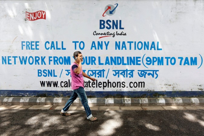 A man speaks on his mobile phone as he walks past a Bharat Sanchar Nigam Ltd (BSNL) advertisement painted on a wall outside its office in Kolkata on August 24, 2017. REUTERS/Rupak De Chowdhuri BSNL