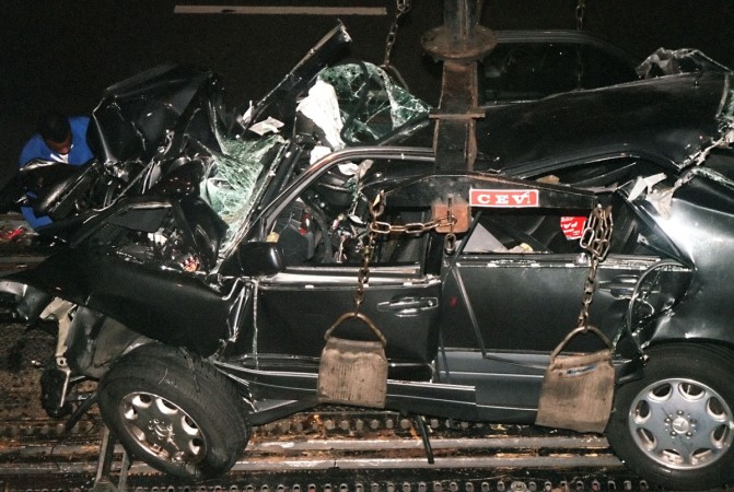 File photo dated 31 August 1997 shows a French police expert (L in the background) working on the wreckage of Princess Diana's car in the Alma tunnel of Paris. Princess Diana death funeral