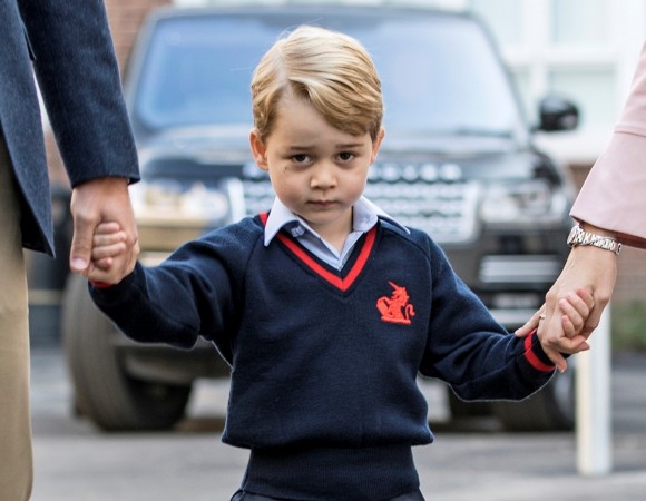   Prince George holds the hand of his father, Prince William, while he arrives at his first day of school at Thomas' School in Battersea, London. 