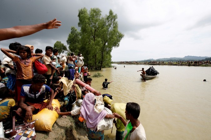 Rohingya refugees wait for boat to cross a canal after crossing the border through the Naf river in Teknaf, Bangladesh, September 7, 2017 Rohingya