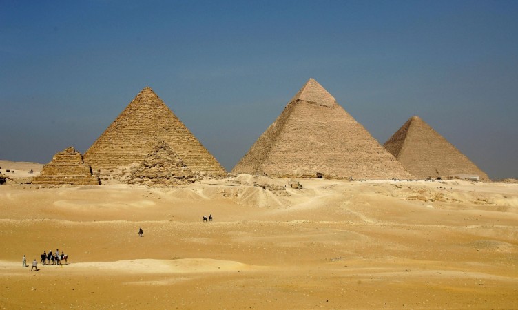 The three large pyramids of Menkaure (L), Khafre (C) and Khufu loom over the horizon November 13, 2004 at Giza, just outside Cairo, Egypt. Egypt