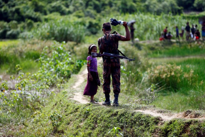A member of Border Guard Bangladesh (BGB) tells a Rohingya girl not to come on Bangladesh side, in Cox's Bazar, Bangladesh A member of Border Guard Bangladesh (BGB) tells a Rohingya girl not to come on Bangladesh side, in Cox's Bazar, Bangladesh