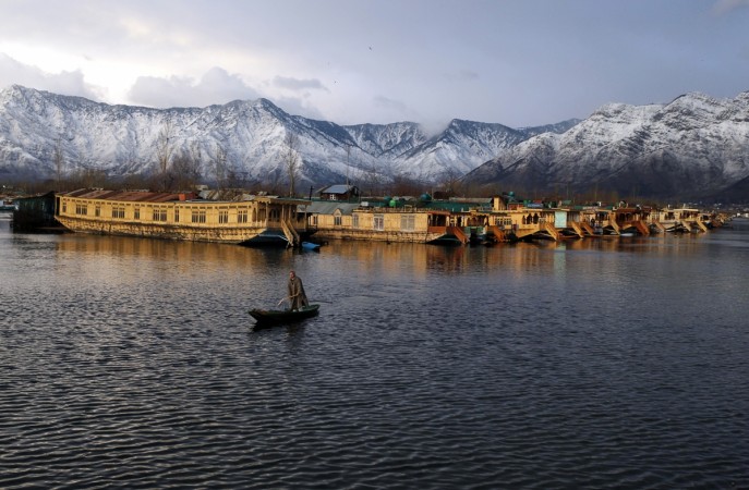 A Kashmiri man rows his boat in the waters of the Dal Lake on a cold winter evening in Srinagar February 5, 2013. India