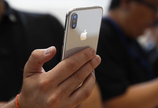 An attendee checks out a new iPhone X during an Apple launch event in Cupertino, California, U.S. September 12, 2017. iPhone X