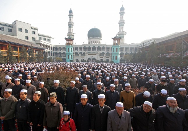 Muslims pray during a ceremony to mark the Eid-al-Fitr Festival Chinese Muslims