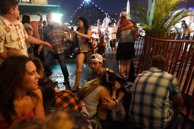 People run for cover at the Route 91 Harvest country music festival after apparent gun fire was heard on October 1, 2017 in Las Vegas, Nevada. Las Vegas shooting