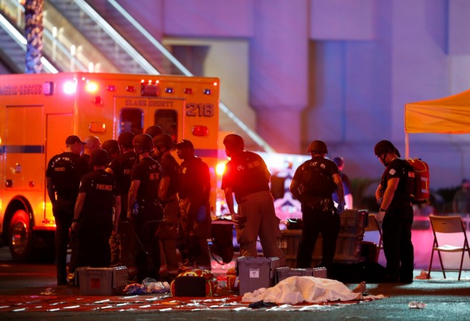 A body is covered with a sheet in the intersection of Tropicana Avenue and Las Vegas Boulevard South after a mass shooting at a music festival Las Vegas shooting