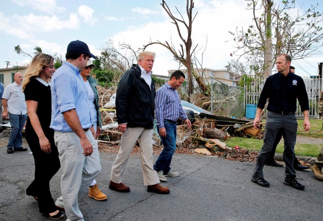 U.S. President Donald Trump walks past hurricane wreckage in Puerto Rico Donald Trump