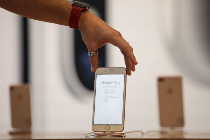 An Apple employee poses with the iPhone 8 on display at Apple Regent Street during the launch of the new phone on September 22, 2017 in London, England. Apple have today launched their new mobile phone the iPhone 8 and 8 plus in the UK today ahead of the iPhone X's release in November. iPhone 8 Plus