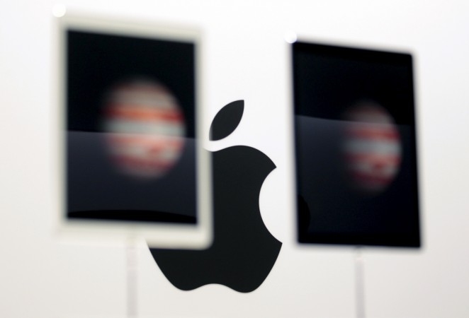 The Apple logo is seen behind new Apple iPad Pros on display during an Apple media event in San Francisco, California, September 9, 2015. Apple iPad Pro