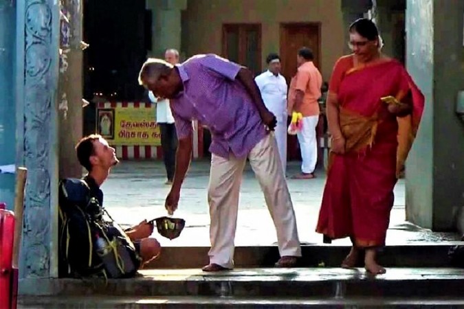 The Russian begging at the Tamil Nadu temple. Russian begging
