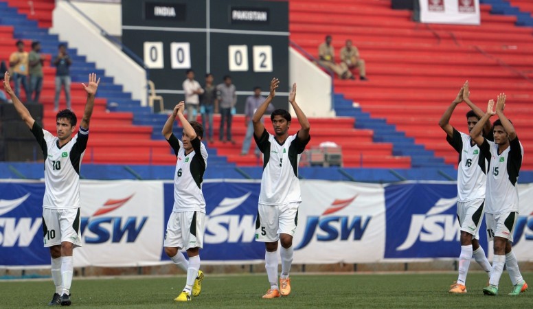 Pakistani football team captain Kaleem Ullah (L) and teammates gesture to spectators as they celebrate their two-goal victory against India during their second friendly football match in Bangalore at the Karnataka State Football Association Stadium in Bangalore on August 20, 2014. pakistan football