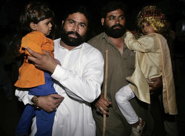 Seven-year-old groom Mohammad Waseem (R) and his four-year-old bride Nisha (L) are escorted by security officials at a police station in Karachi October 31, 2008. Pakistani police raided a child marriage ceremony in the city of Karachi and arrested a cleric who was presiding over the wedding of a 4-year-old girl and a 7-year-old boy. child marriage in pakistan