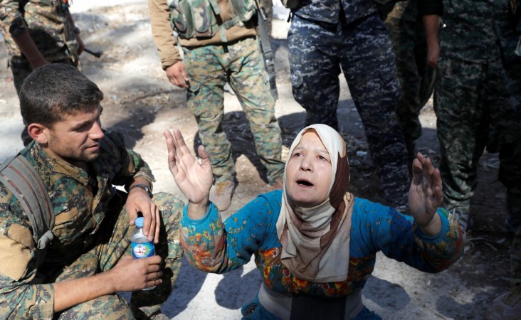 In picture: A civilian prays after she was rescued by fighters of Syrian Democratic Forces from the stadium after Raqqa was liberated from the Islamic State militants in Raqqa, Syria, October 17, 2017. Raqqa