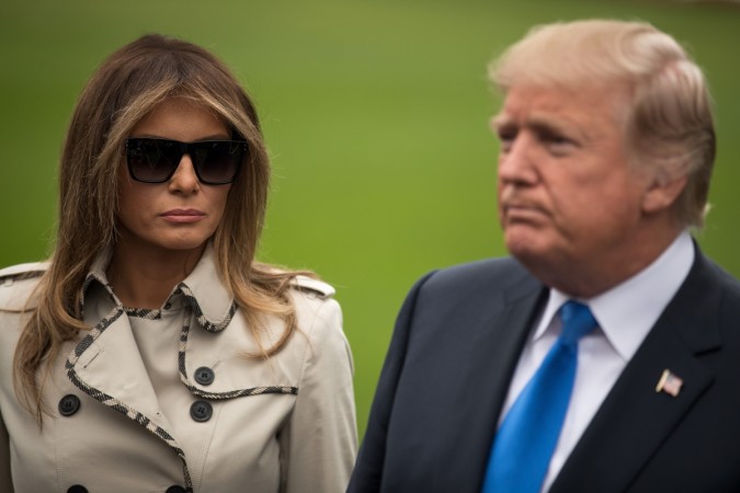 (L to R) First Lady Melania Trump looks on as U.S. President Donald Trump takes questions from reporters, on their way to Marine One on the South Lawn of the White House, October 13, 2017 in Washington, DC. Melania Trump