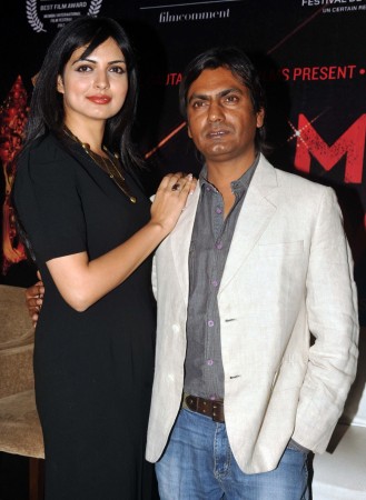 Indian Bollywood actors Nawazuddin Siddiqui (R) and Niharika Singh pose during the first look of upcoming Hindi film 'Miss Lovely' in Mumbai on December 23, 2013. Nawazuddin Siddqui