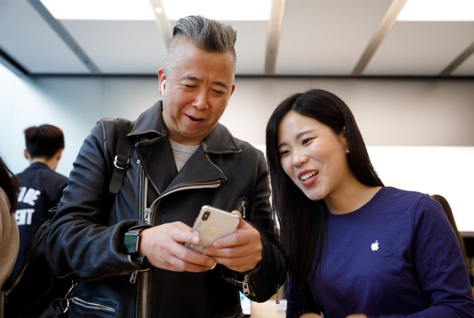 Coronavirus outbreak has global impact in tech space Customer with iPhone X in Shanghai, China