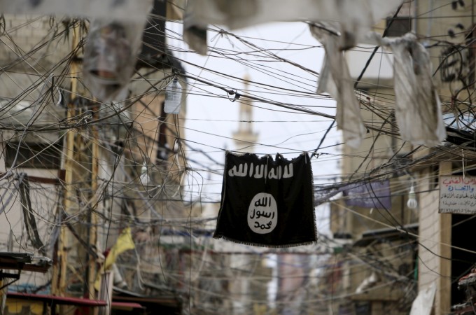 An Islamic State flag hangs amid electric wires over a street in Ain al-Hilweh Palestinian refugee camp, near the port-city of Sidon, southern Lebanon January 19, 2016. isis flag