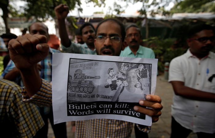 A protester displays a placard during a protest rally against the killing of Gauri Lankesh, an Indian journalist, in New Delhi, India, September 6, 2017. lankesh killed