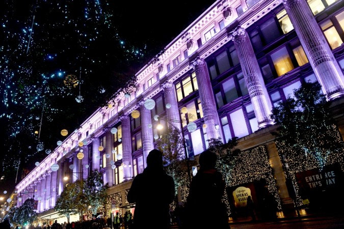 People take photographs of the Oxford Street Christmas lights, in London Christmas in London