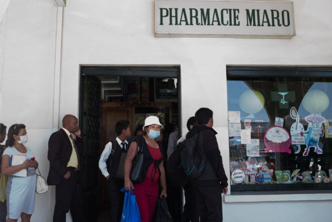People queue at a pharmacy in downtown Antananarivo to buy protection masks against infections and medicines against plague. Black Death Plague