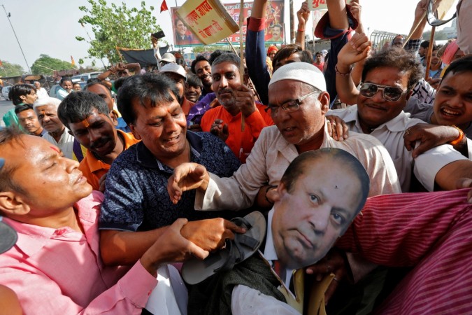 People beat an effigy of Pakistan's Prime Minister Nawaz Sharif during a protest against what they say is the death sentence given to former Indian naval officer Kulbhushan Jadhav in Pakistan, in Lucknow, India April 11, 2017. Pakistan PM's effigy burnt in lucknow