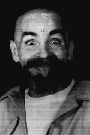 Charles Manson clowns around as he is led to his cell upon the conclusion of his exclusive interview with Reuters August 25, 1989. Charles Manson