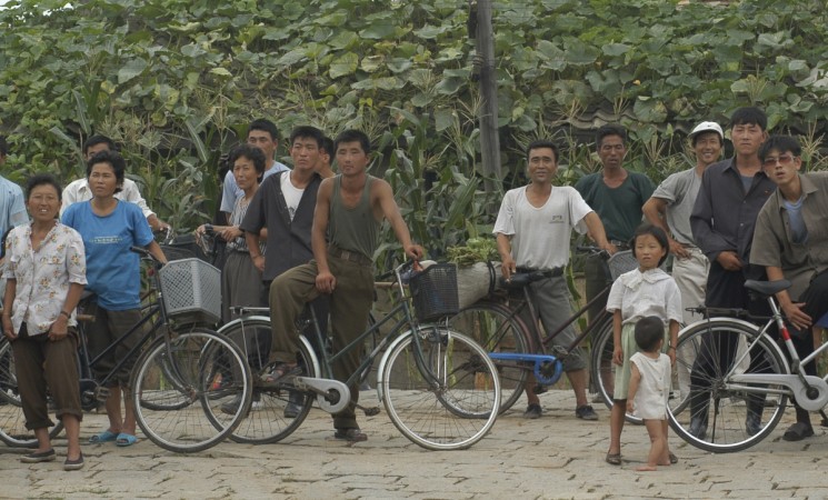 People watch a performance in a village in the Onchon County near Pyongyang, North Korea August 12, 2005. Picture taken August 12, 2005. North Korea