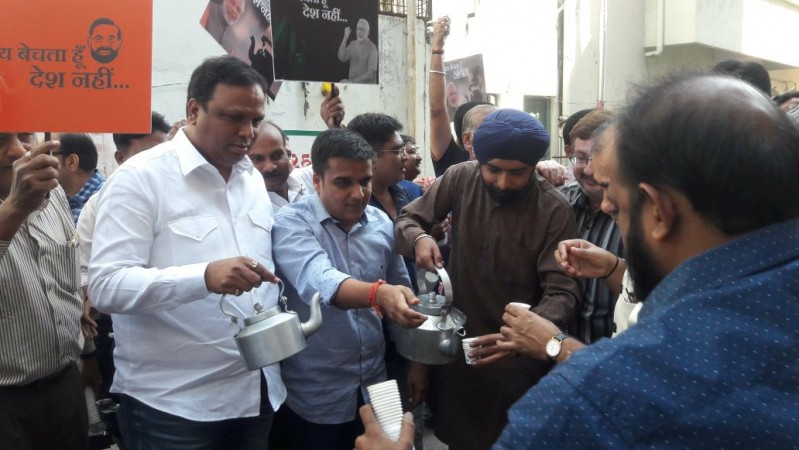 From left: BJP leaders Ashish Shelar (from Maharashtra), Harish Sanghvi (from Gujarat) and Tajindar Pal Singh Bagga (Delhi) distribute tea in front of the Congress party office in Surat on Wednesday, November 22, 2017. BJP distributes tea