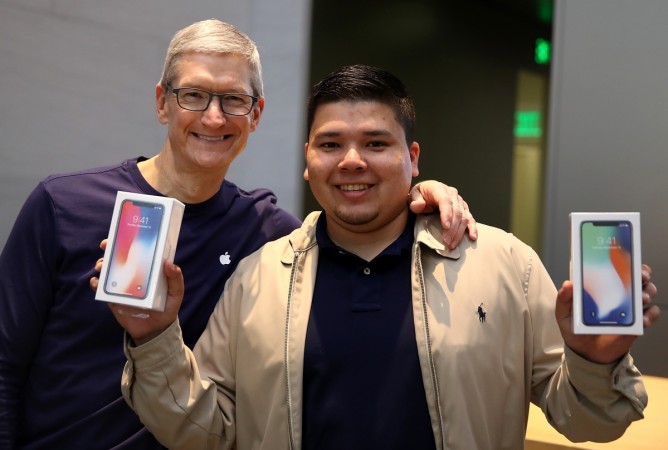 PALO ALTO, CA - NOVEMBER 03: Apple CEO Tim Cook (L) takes a picture with David Casarez (R) who just purchased the new iPhone X at an Apple Store on November 3, 2017 in Palo Alto, California. The highly anticipated iPhone X went on sale around the world today. Apple's New iPhone X Goes On Sale In Stores