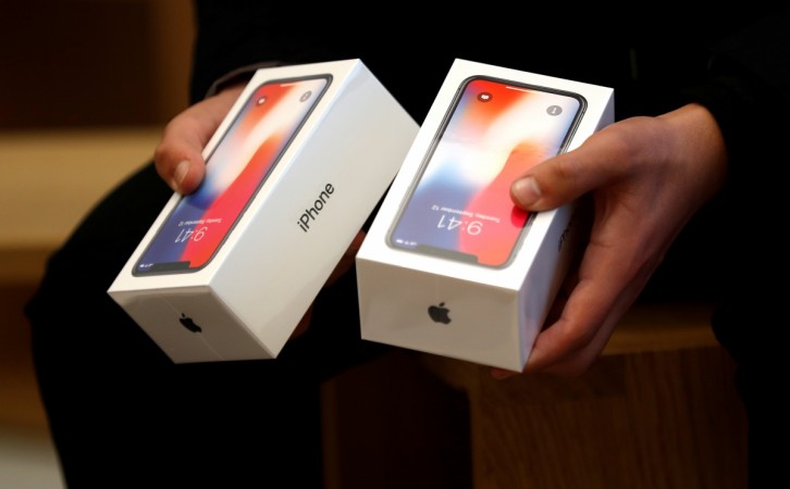 A man holds two boxes for the Apple's new iPhone X at the Apple Store in Regents Street in London, Britain, November 3, 2017. Apple iPhone X