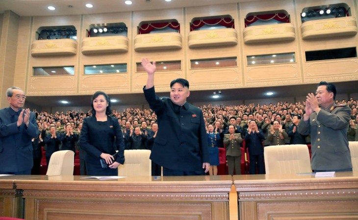 Kim Jong-un waves upon his arrival with his wife Ri Sol-ju for a performance given by the Song and Dance Ensemble of the Korean People's Internal Security Forces Ri Sol-ju