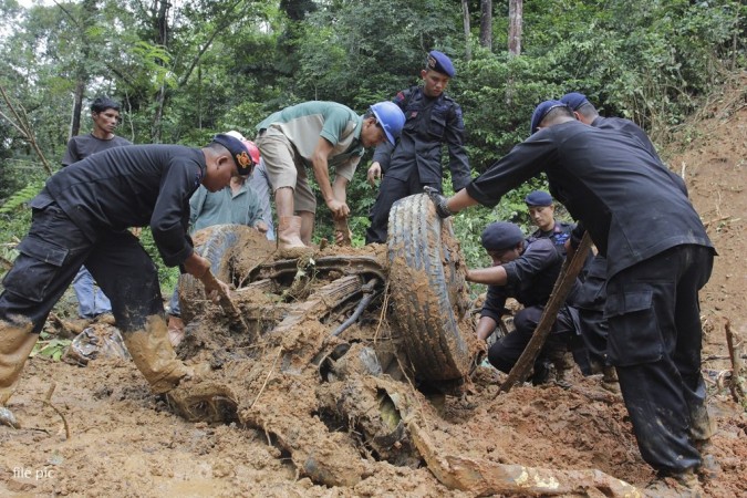 In picture: People clear debris after a landslide in the East Java province of Indonesia. Indonesia