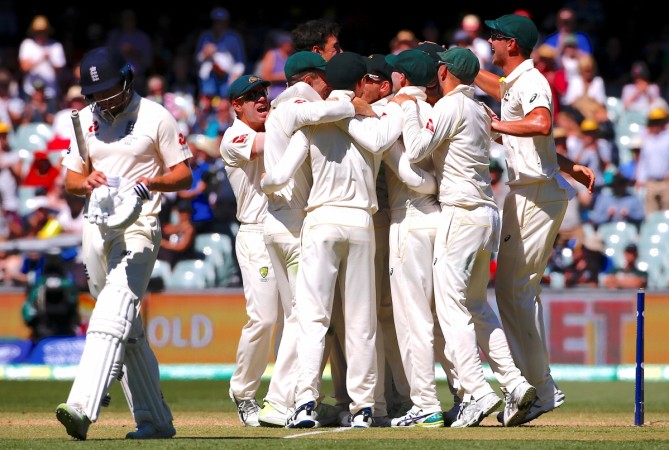 Australian players (right) celebrate second Test win. Jonny Bairstow (left) was the last man out, to Mitchell Starc. Australia Ashes Test